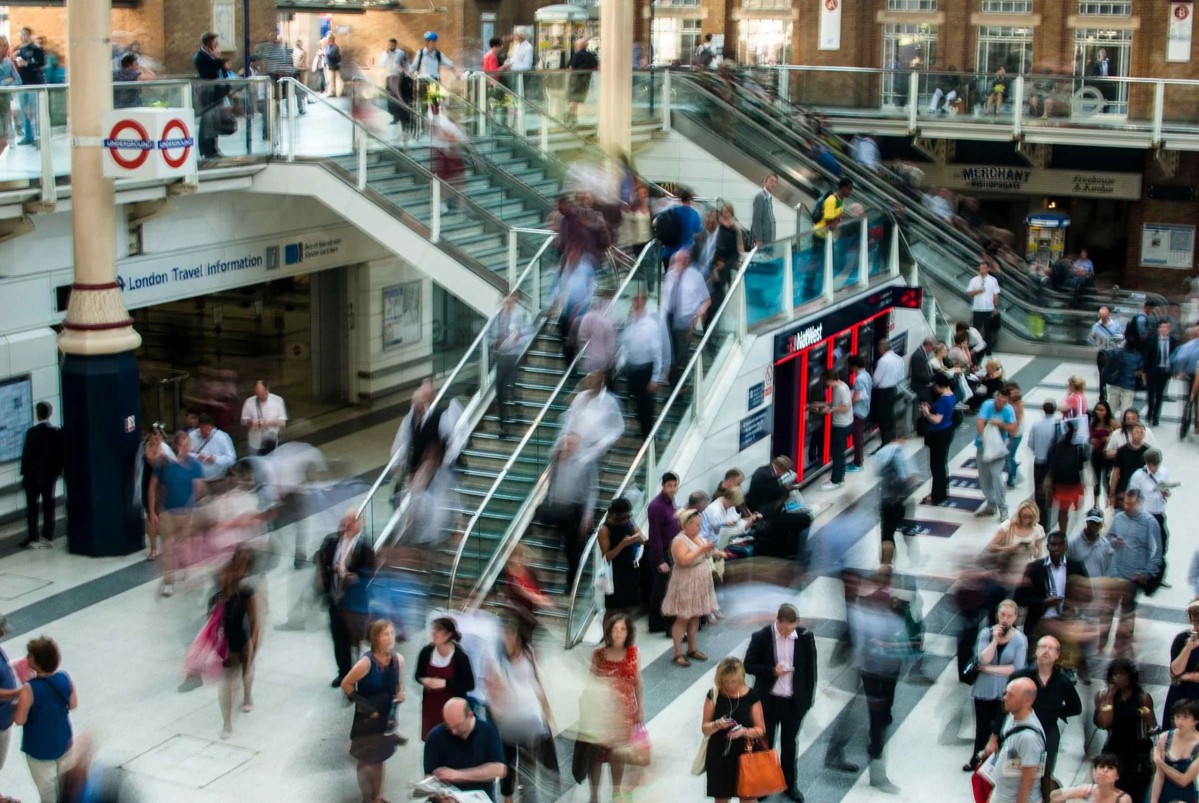 Commuters moving through a station in long-exposure blur